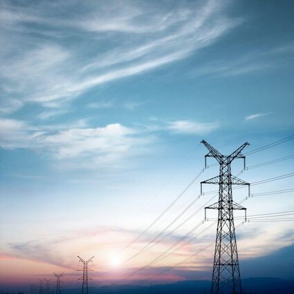 High voltage lines set against an evening sky at sundown